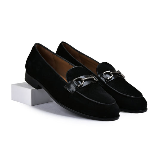 Pair of brown leather loafers with gold accents on a white background