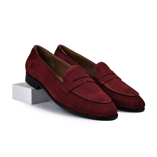 Pair of red loafers on a white background