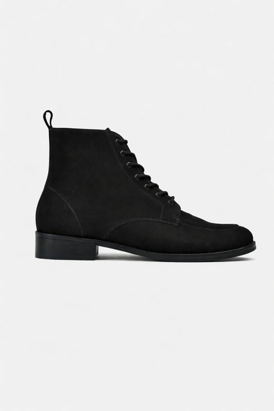 Black suede lace-up boot on a light gray background