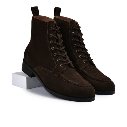 Pair of brown suede boots on a white background