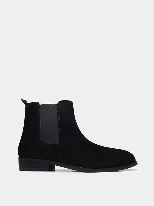 A men's luxury suede leather Chelsea boot with a mid heel and elastic side panels, in a black color.