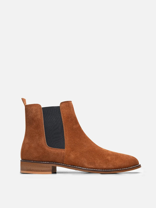 A men's luxury suede leather Chelsea boot with a mid heel and elastic side panels, in a tan color.