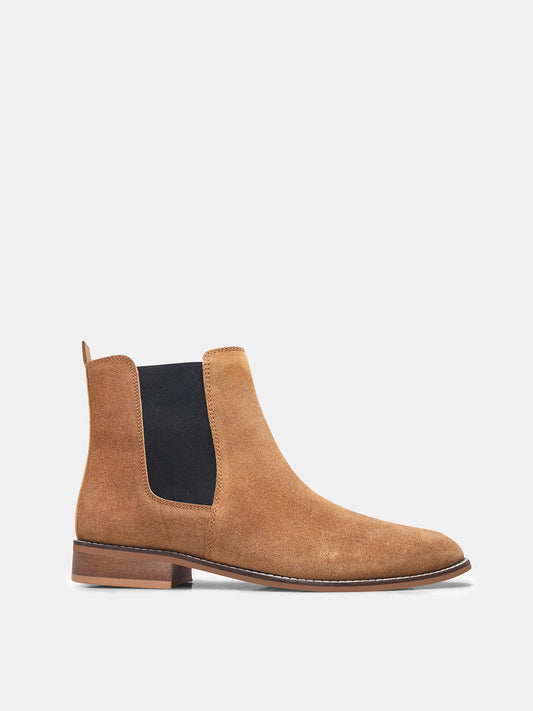 A men's luxury suede leather Chelsea boot with a mid heel and elastic side panels, in a tan color.