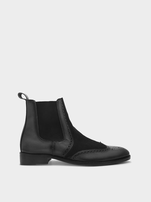 Black Chelsea boot on a white The Wing (Black) - Wingtip Brogue Chelsea Boots | RNK LUXE