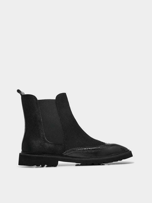 Black Chelsea boot on a white background