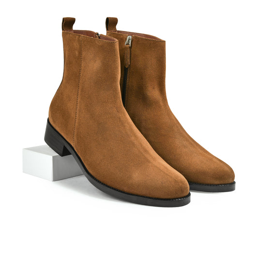 Pair of brown suede ankle boots on a white background