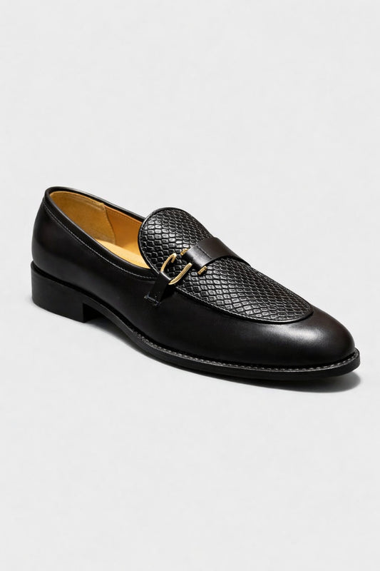 Black loafer shoe on a light gray background
