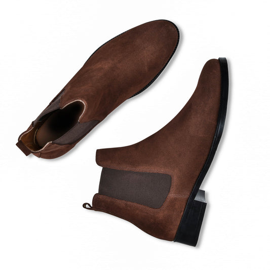 Brown suede ankle boots on a white background