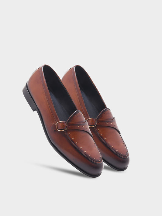 Pair of brown leather loafers on a light gray background