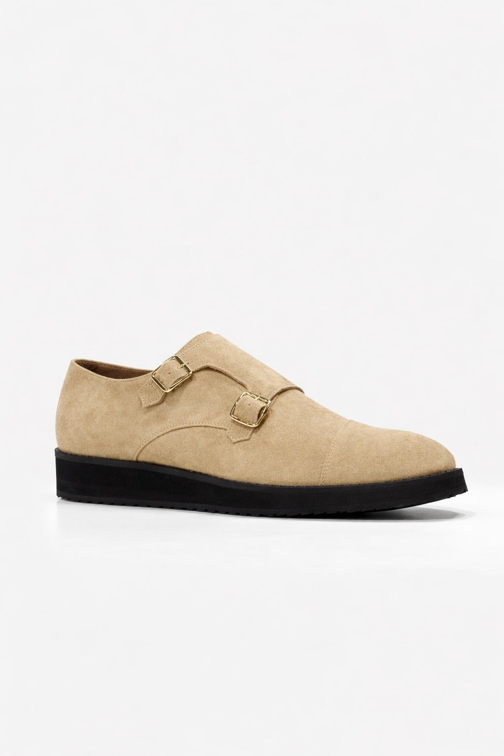 Beige suede shoe with black sole on a white background