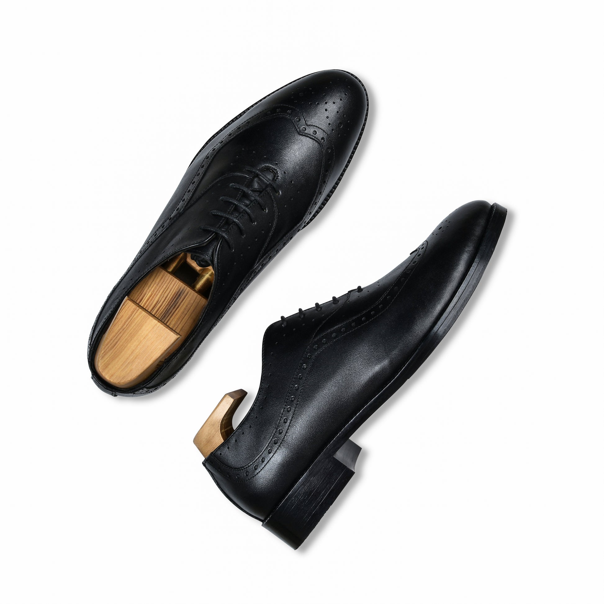 Pair of black leather dress shoes on a white background