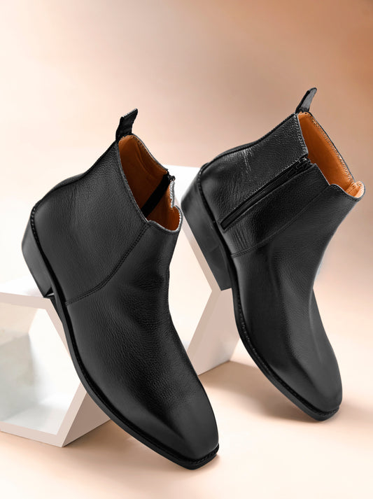A men's leather side zip boot with a cuban heel, primarily black in color.