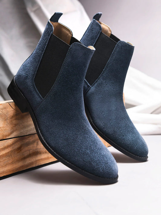 A men's luxury suede leather Chelsea boot with a cuban heel and elastic side panels, in a blue color.