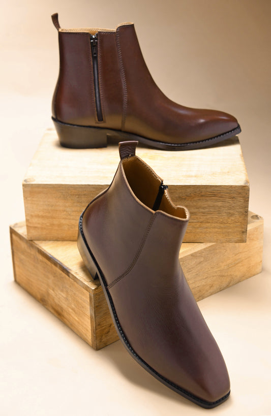 A brown, side zip leather boot with a cuban heel for men.