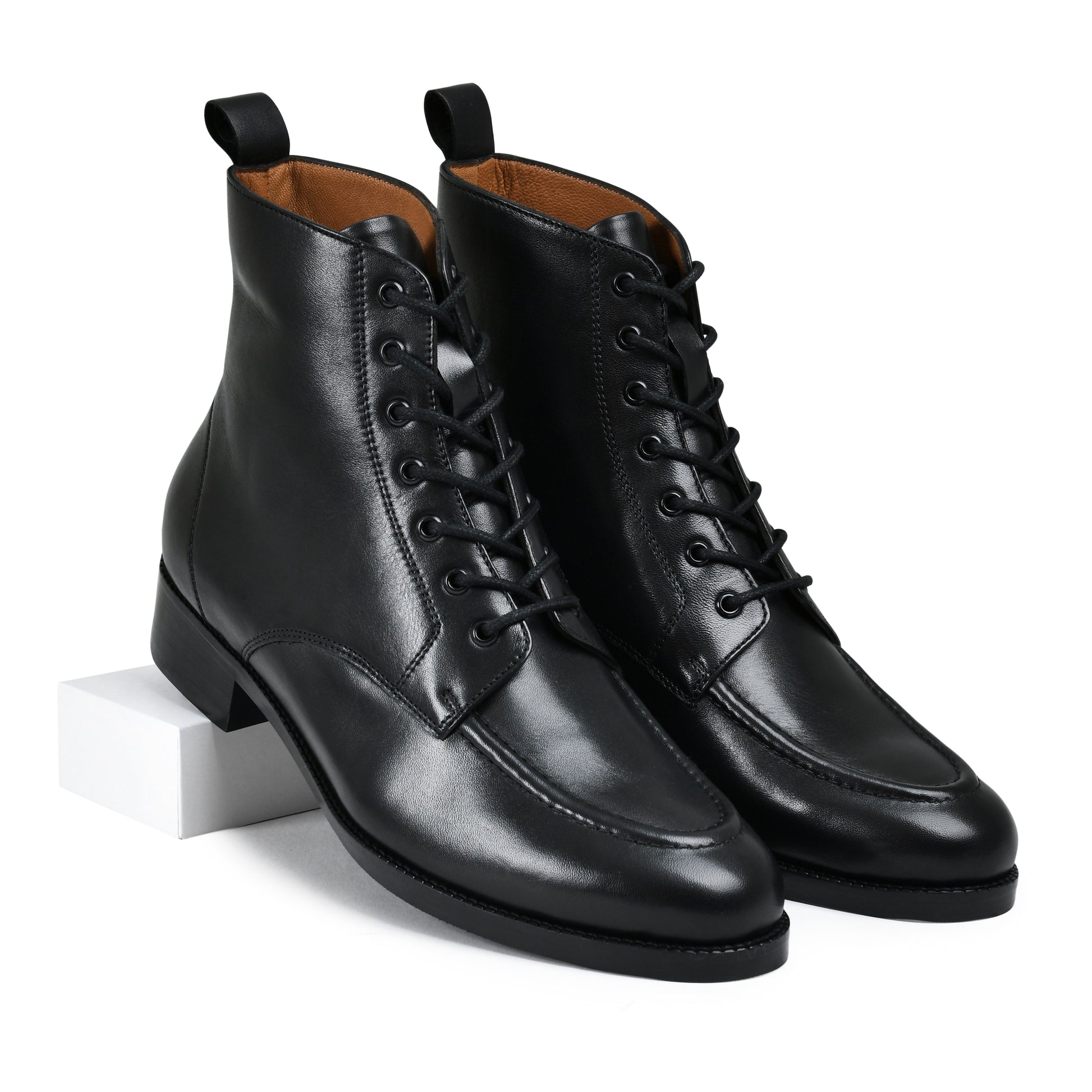 Pair of black leather boots on a white background