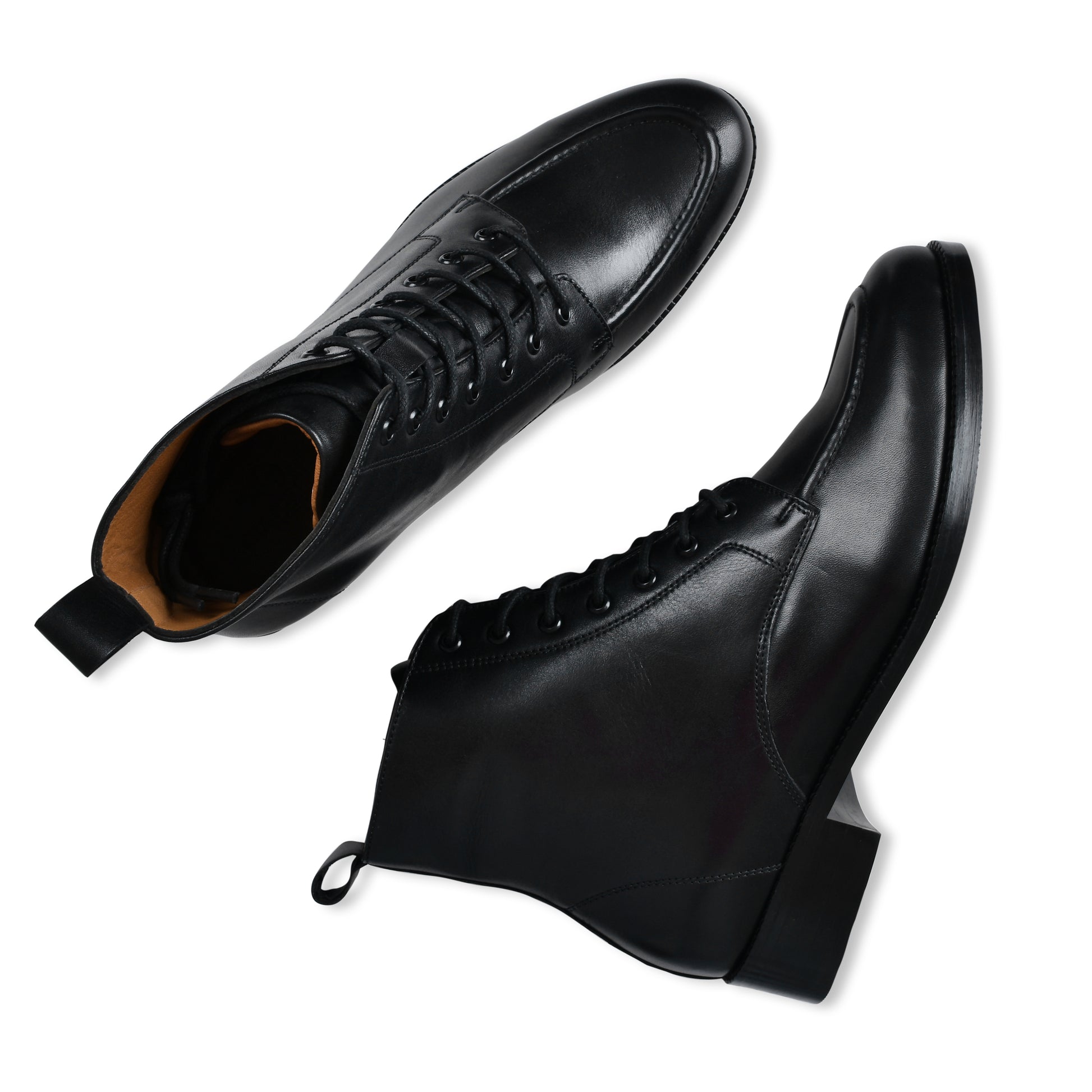 Pair of black leather boots on a white background