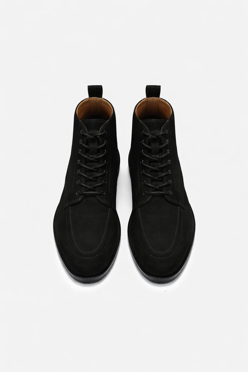 Black suede boots on a white background