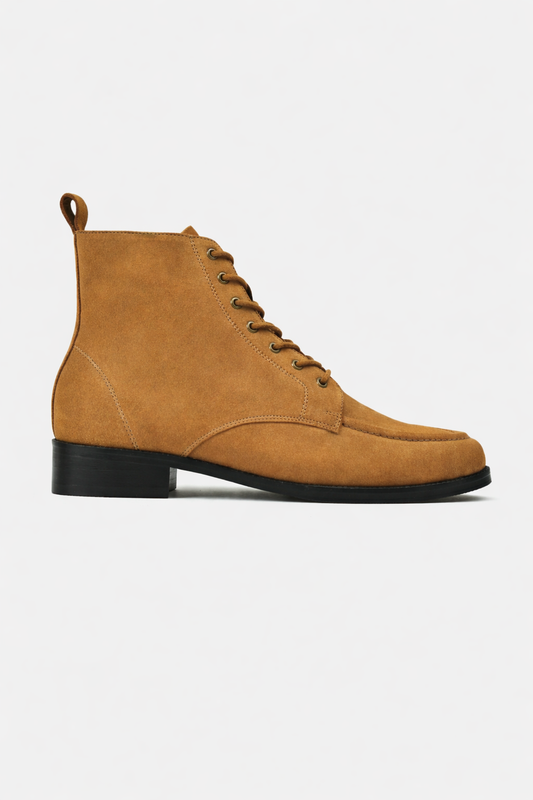 Tan suede boot with black sole on a white background