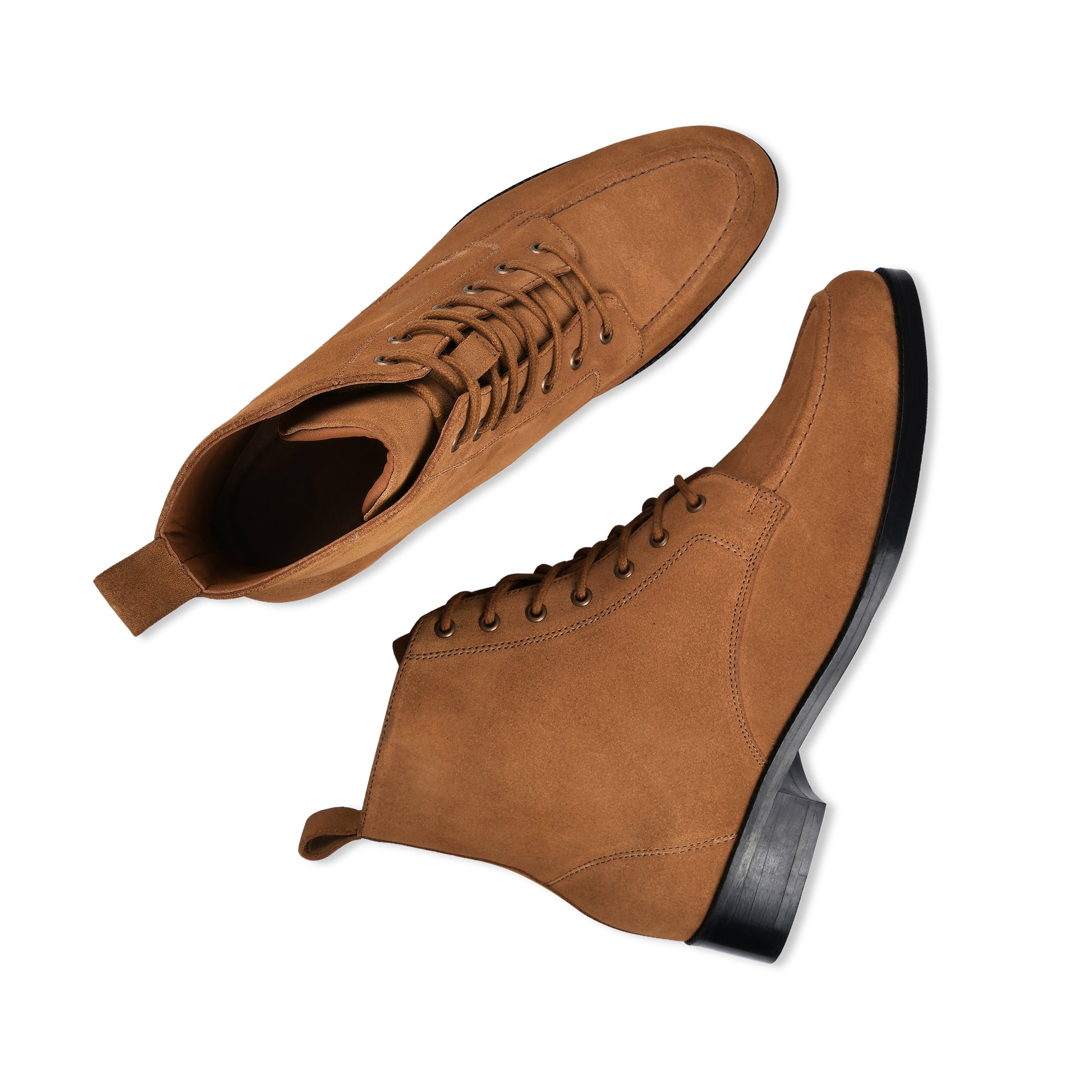Pair of brown suede boots on a white background