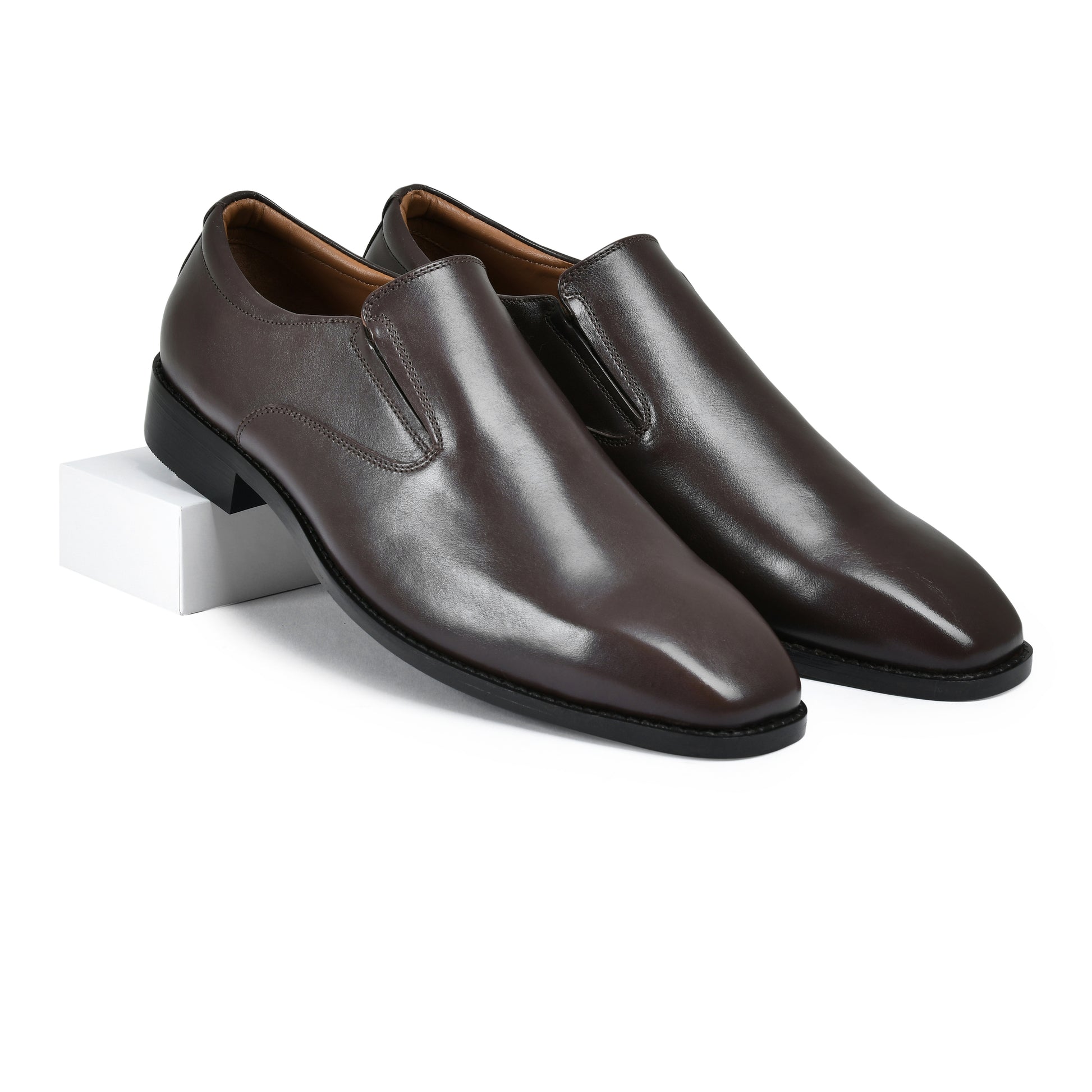 Pair of brown leather shoes on a white background