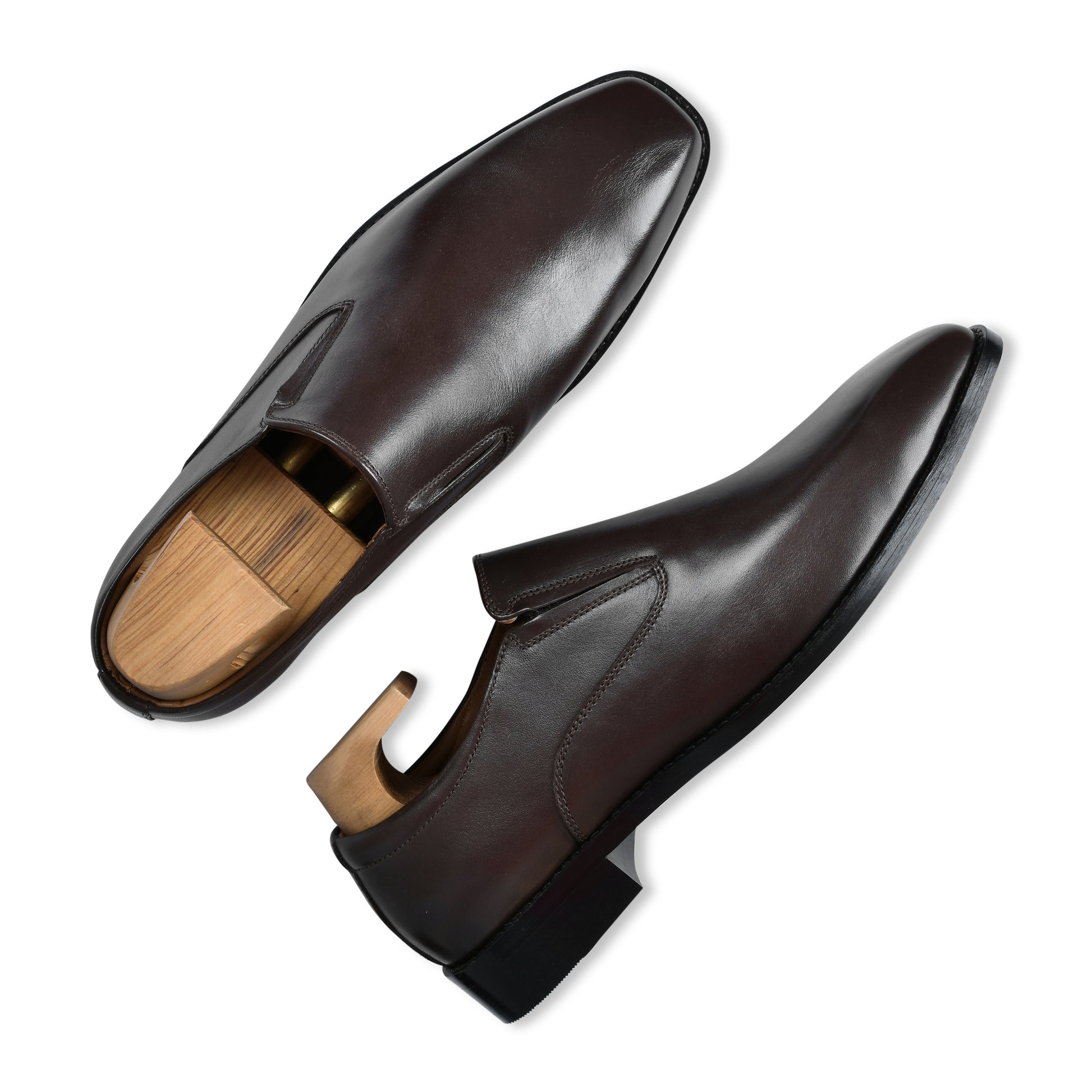 Brown leather shoes with wooden soles on a white background
