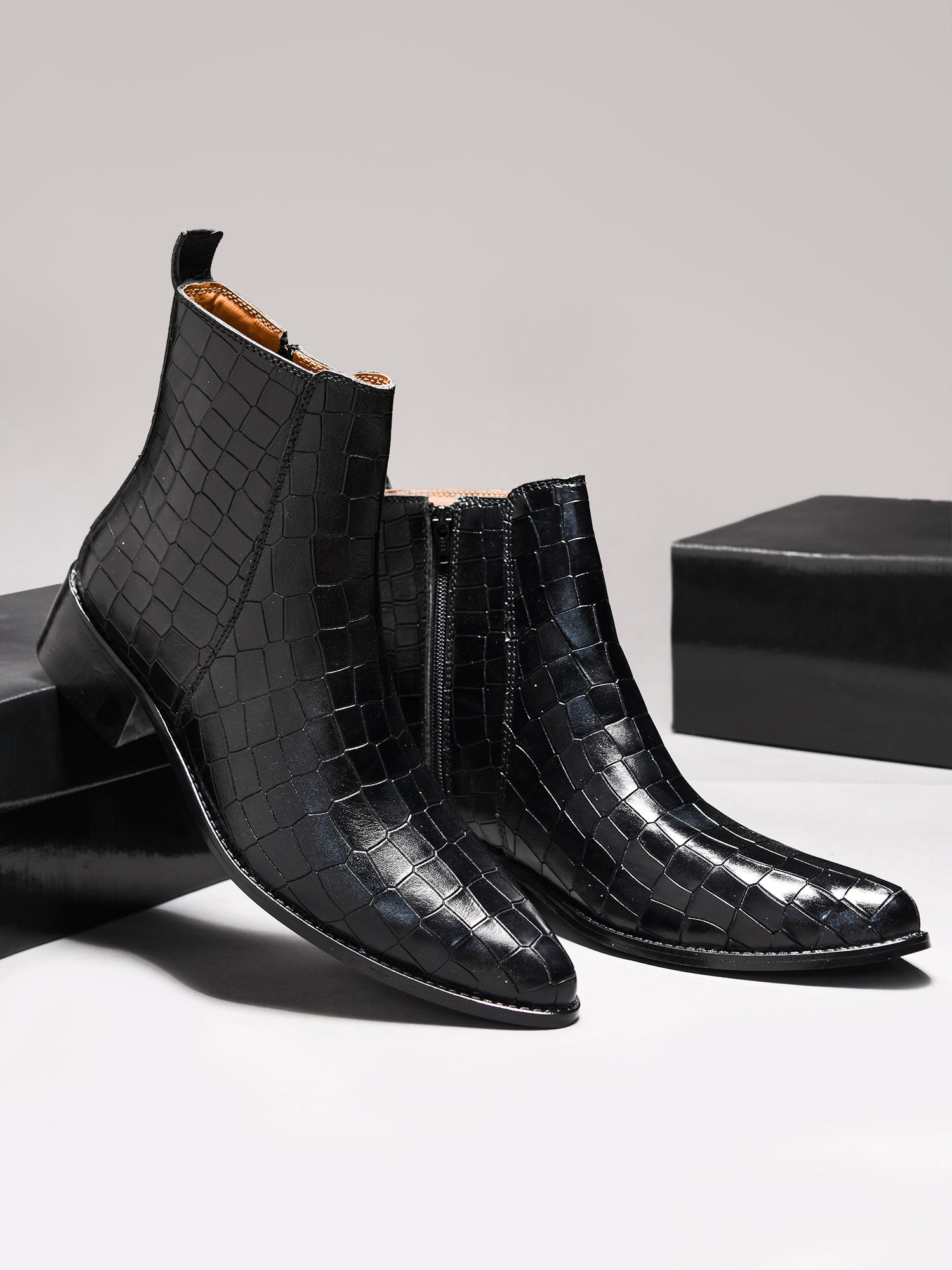 Men’s black crocodile-textured leather Chelsea boots with a sleek, pointed toe design