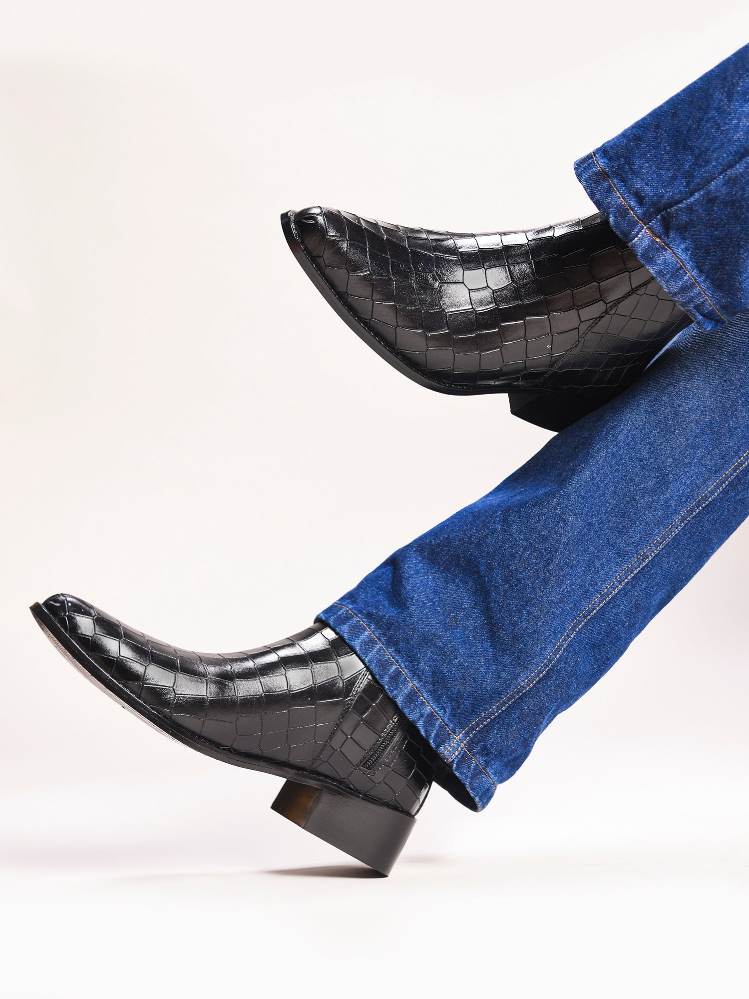 Men’s black crocodile-textured leather Chelsea boots with a sleek, pointed toe design