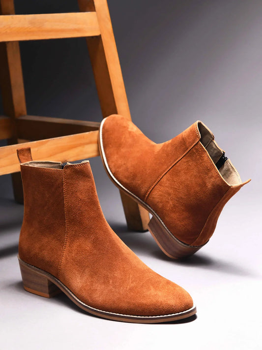 A men's luxury suede leather Chelsea boot with a cuban heel and zip side panels, in a tan color.