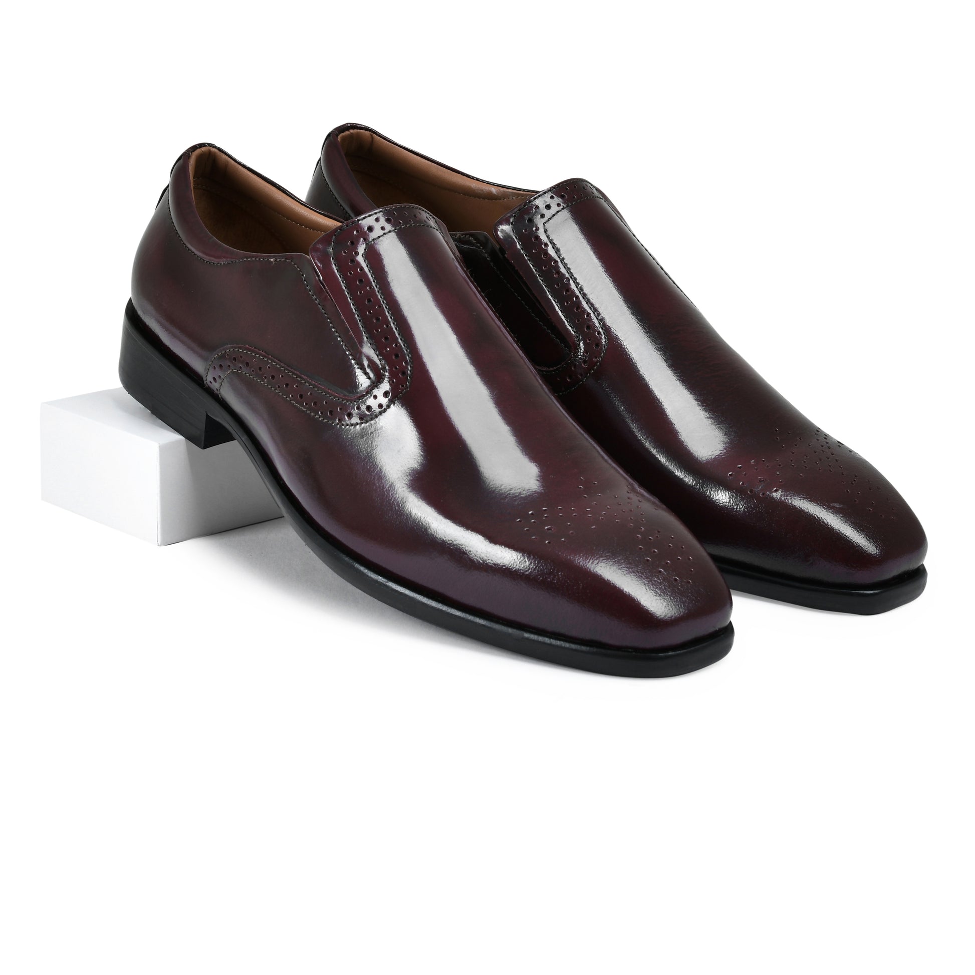 Pair of glossy brown dress shoes on a white background