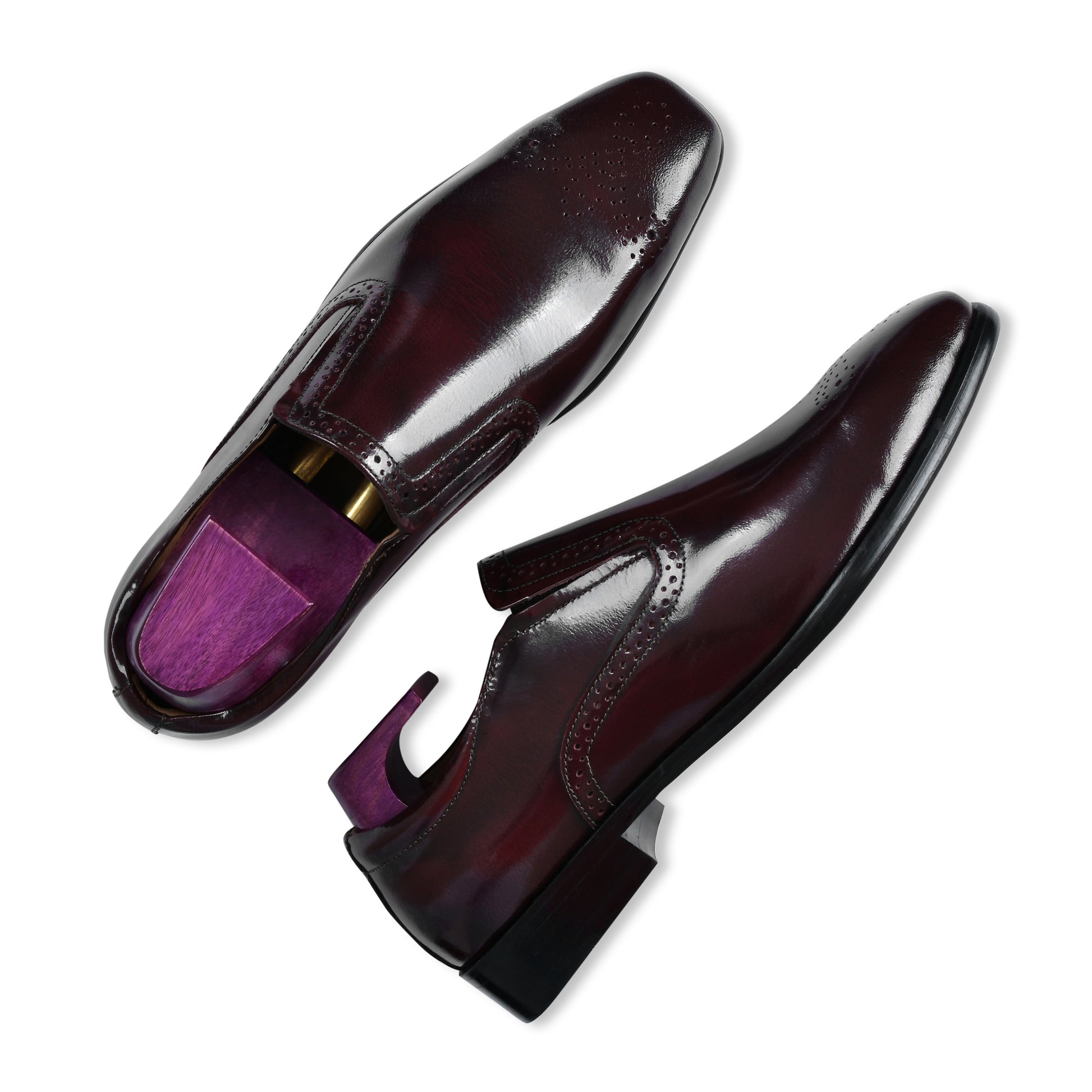 Shiny black dress shoes on a white background