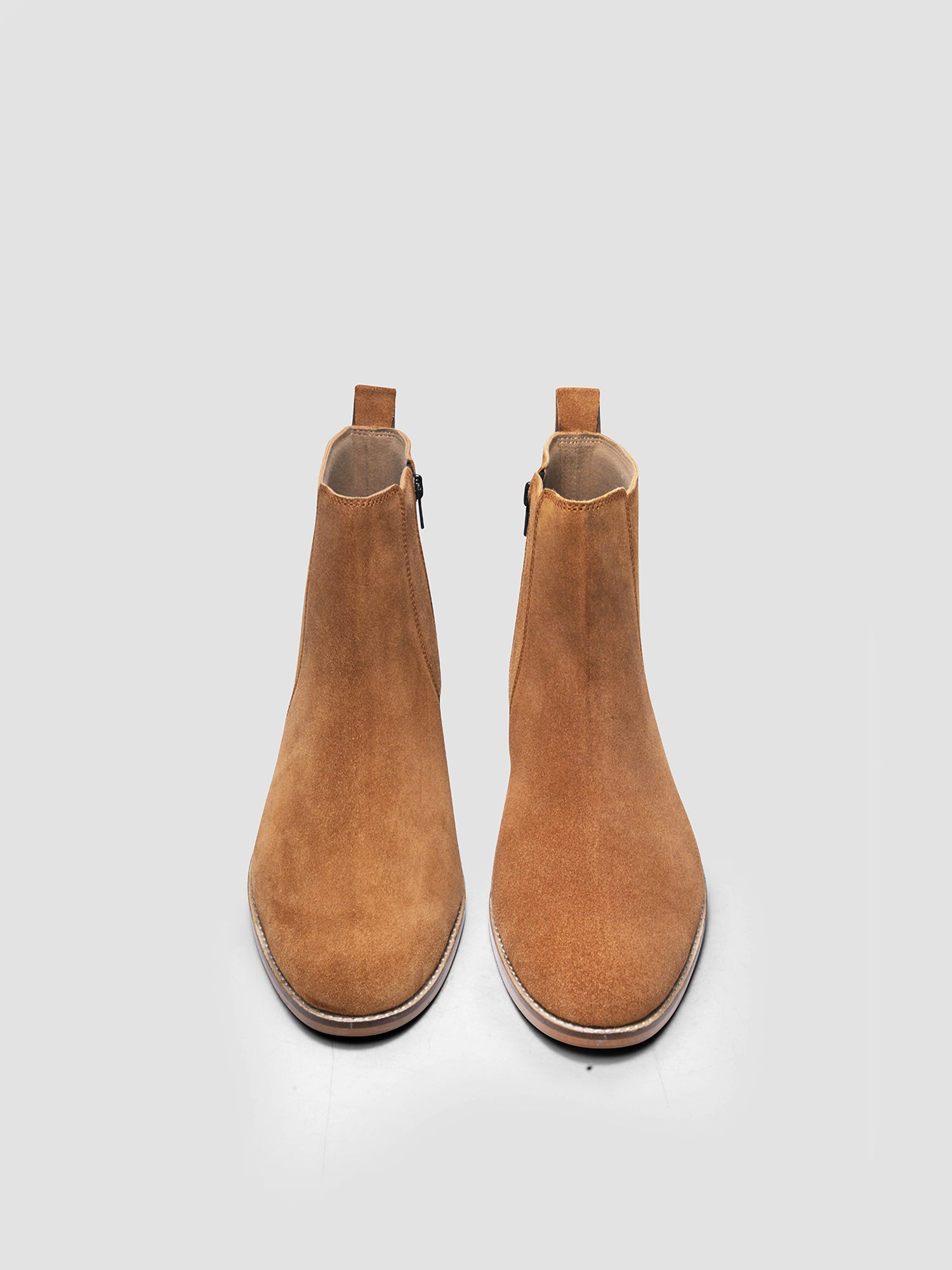 A men's luxury suede leather Chelsea boot with a cuban heel and zip side panels, in a camel color.