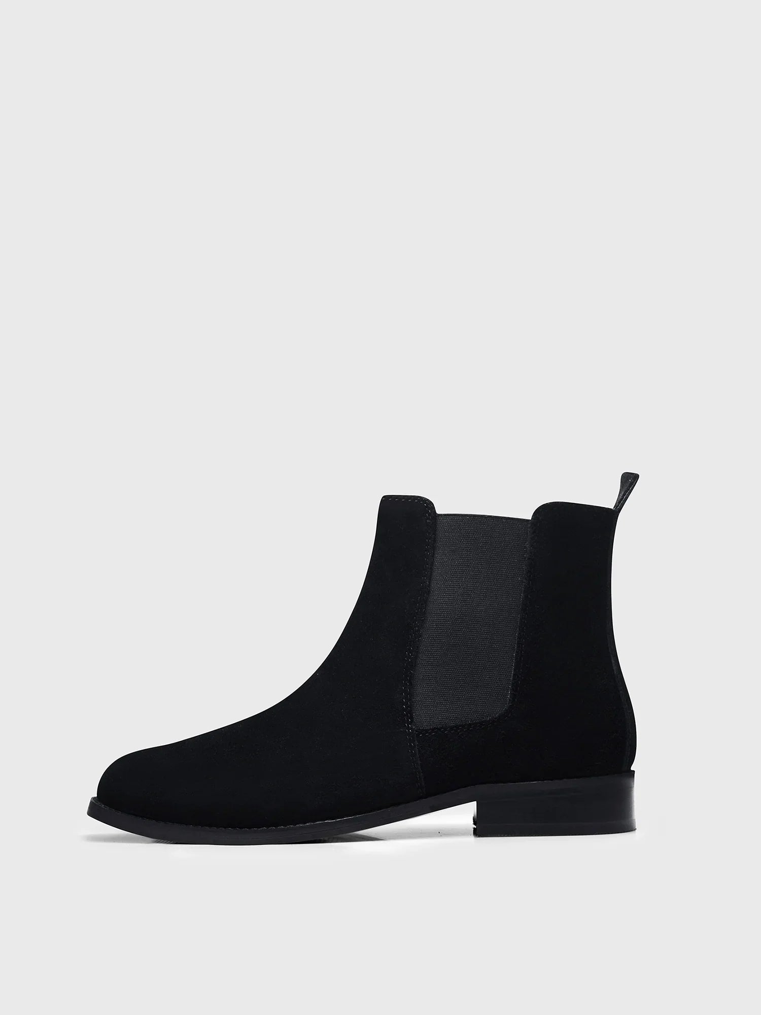 A men's luxury suede leather Chelsea boot with a mid heel and elastic side panels, in a black color.