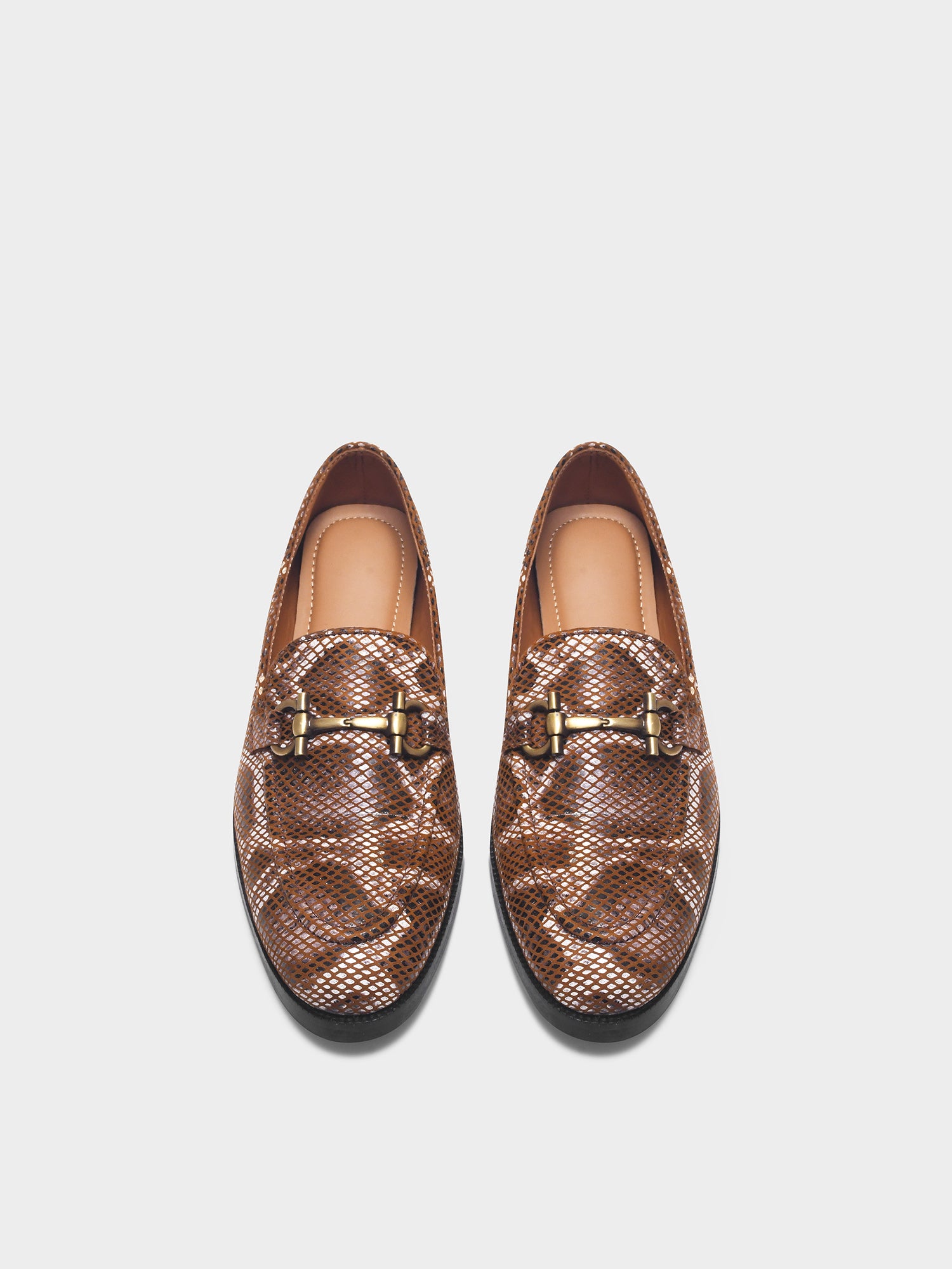 Pair of brown patterned loafers with gold buckles on a white background