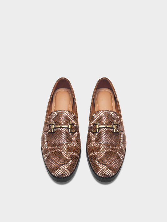 Pair of brown patterned loafers with gold buckles on a white background