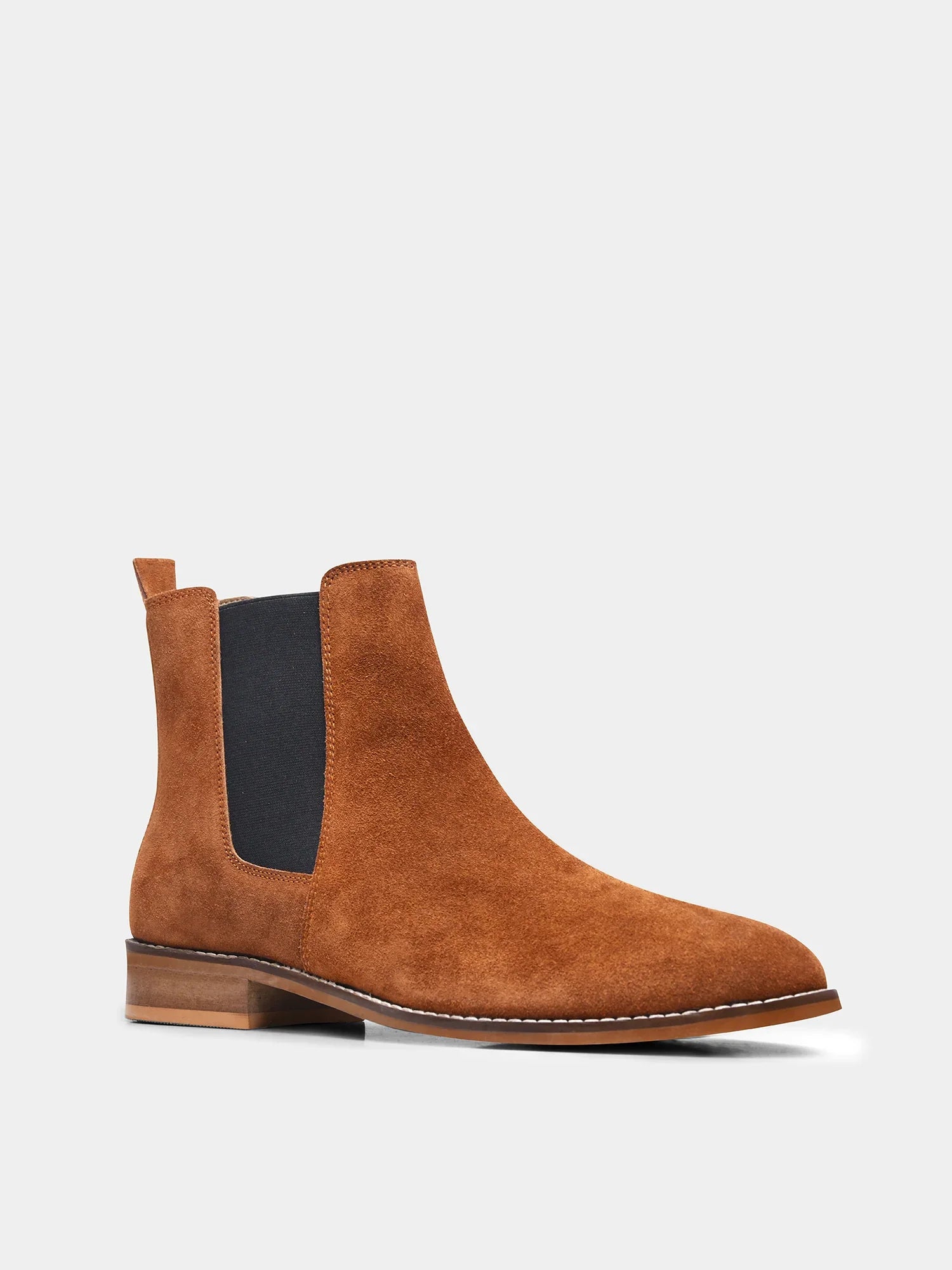 A men's luxury suede leather Chelsea boot with a mid heel and elastic side panels, in a tan color.