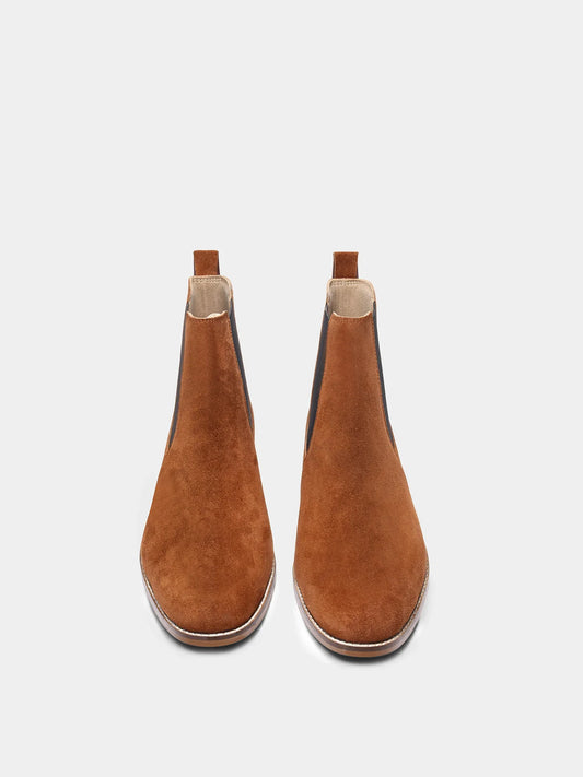 A men's luxury suede leather Chelsea boot with a mid heel and elastic side panels, in a tan color.