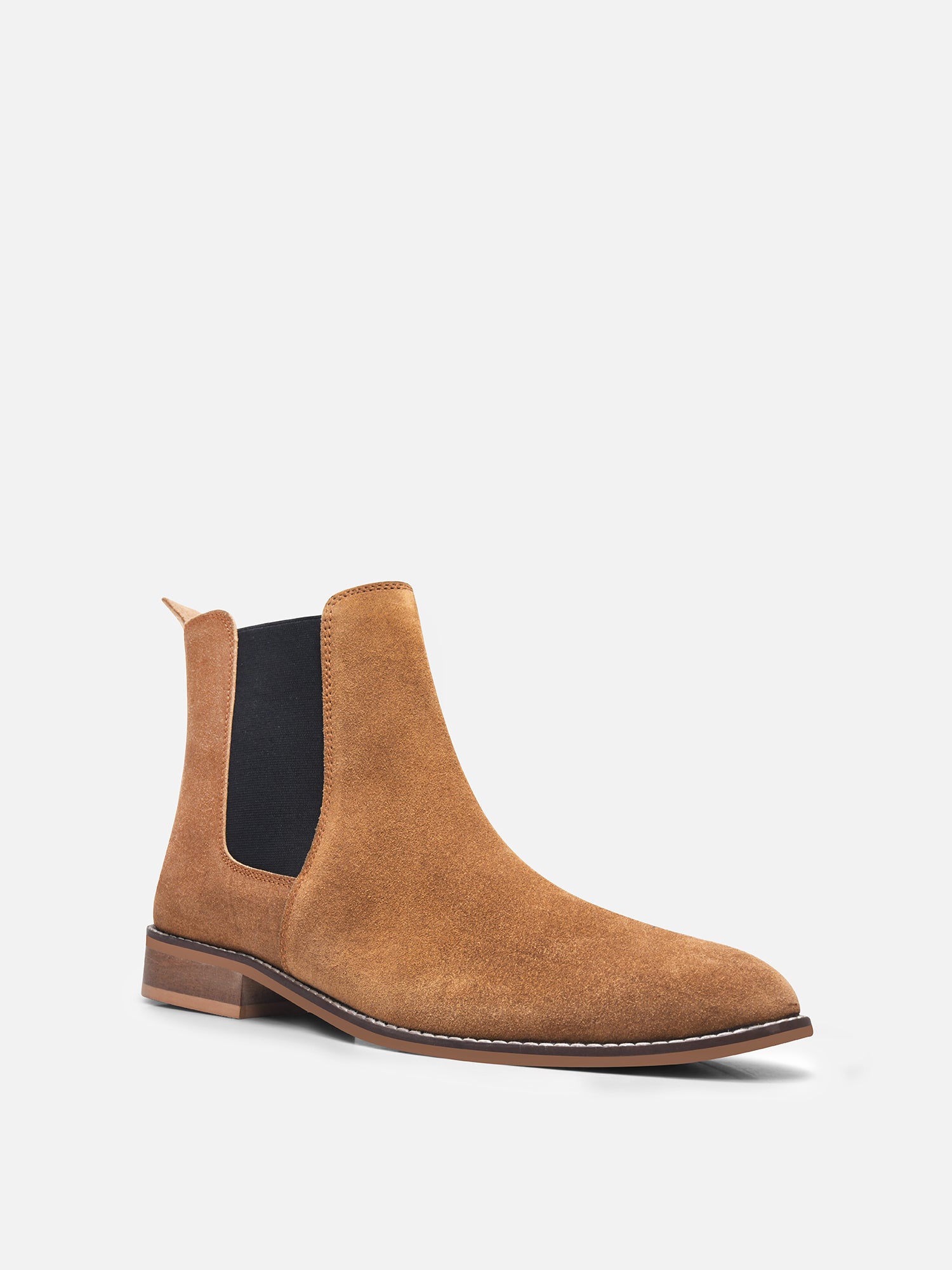 A men's luxury suede leather Chelsea boot with a mid heel and elastic side panels, in a tan color.