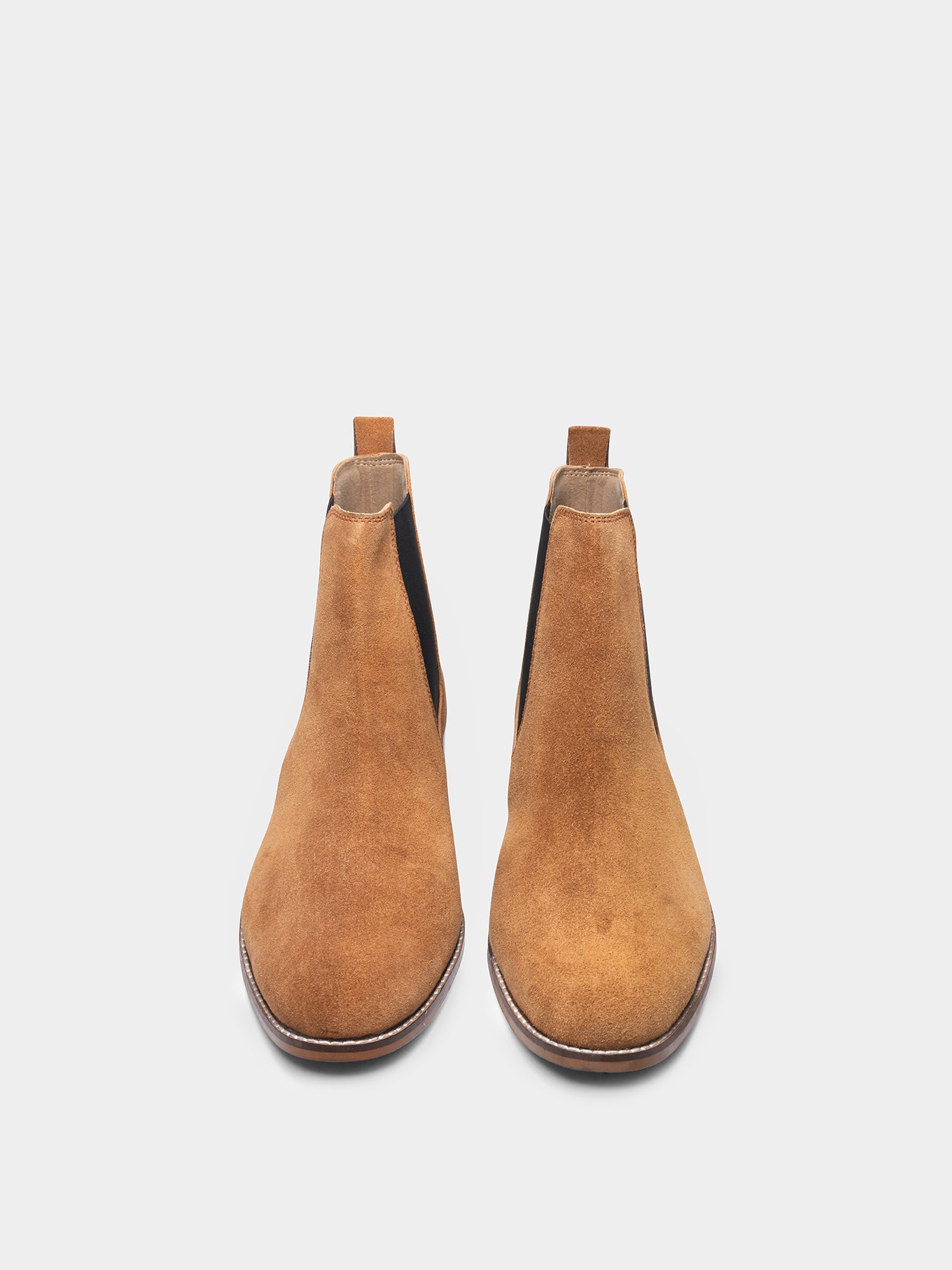 A men's luxury suede leather Chelsea boot with a mid heel and elastic side panels, in a tan color.