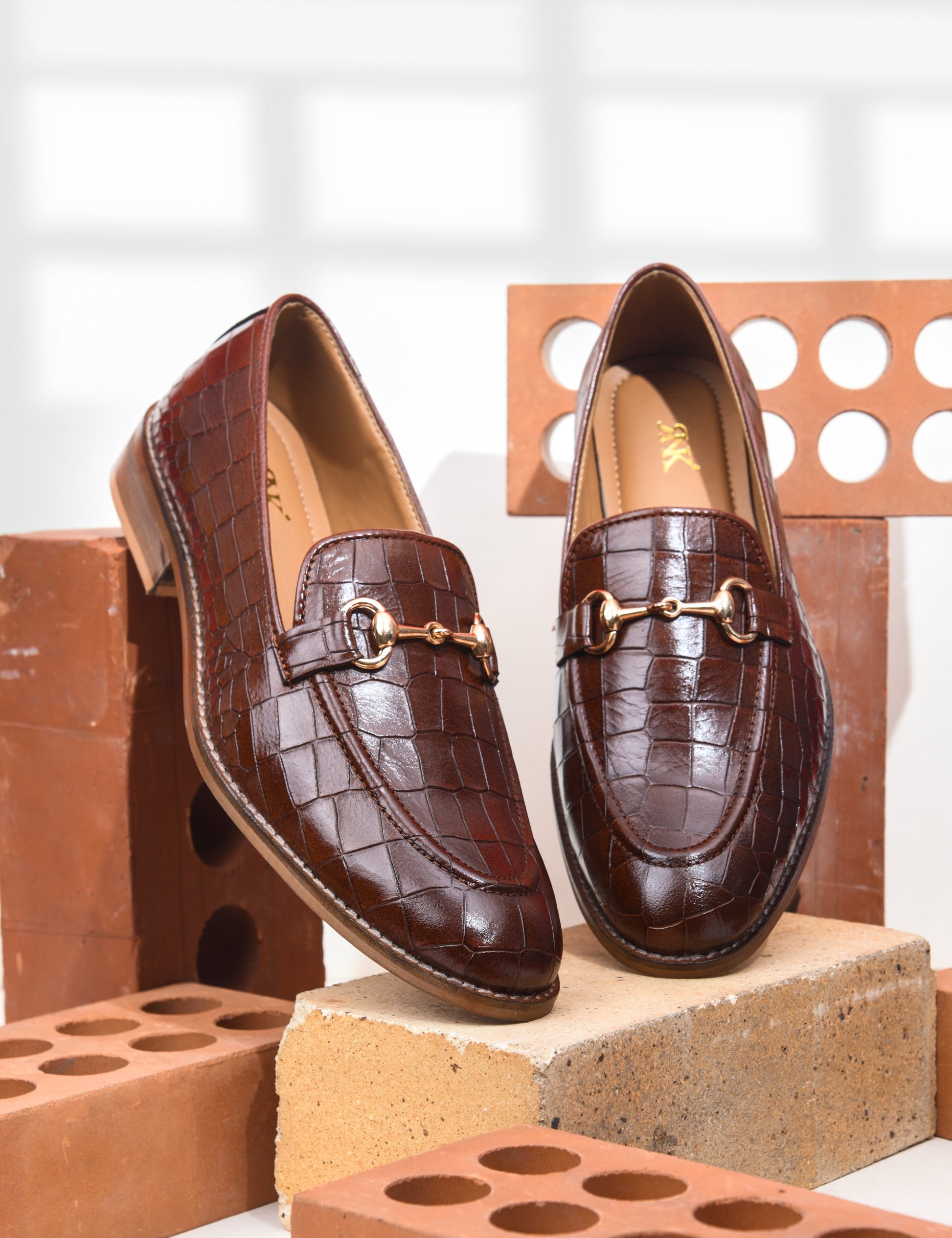 Tan leather horsebit loafers in crocodile texture