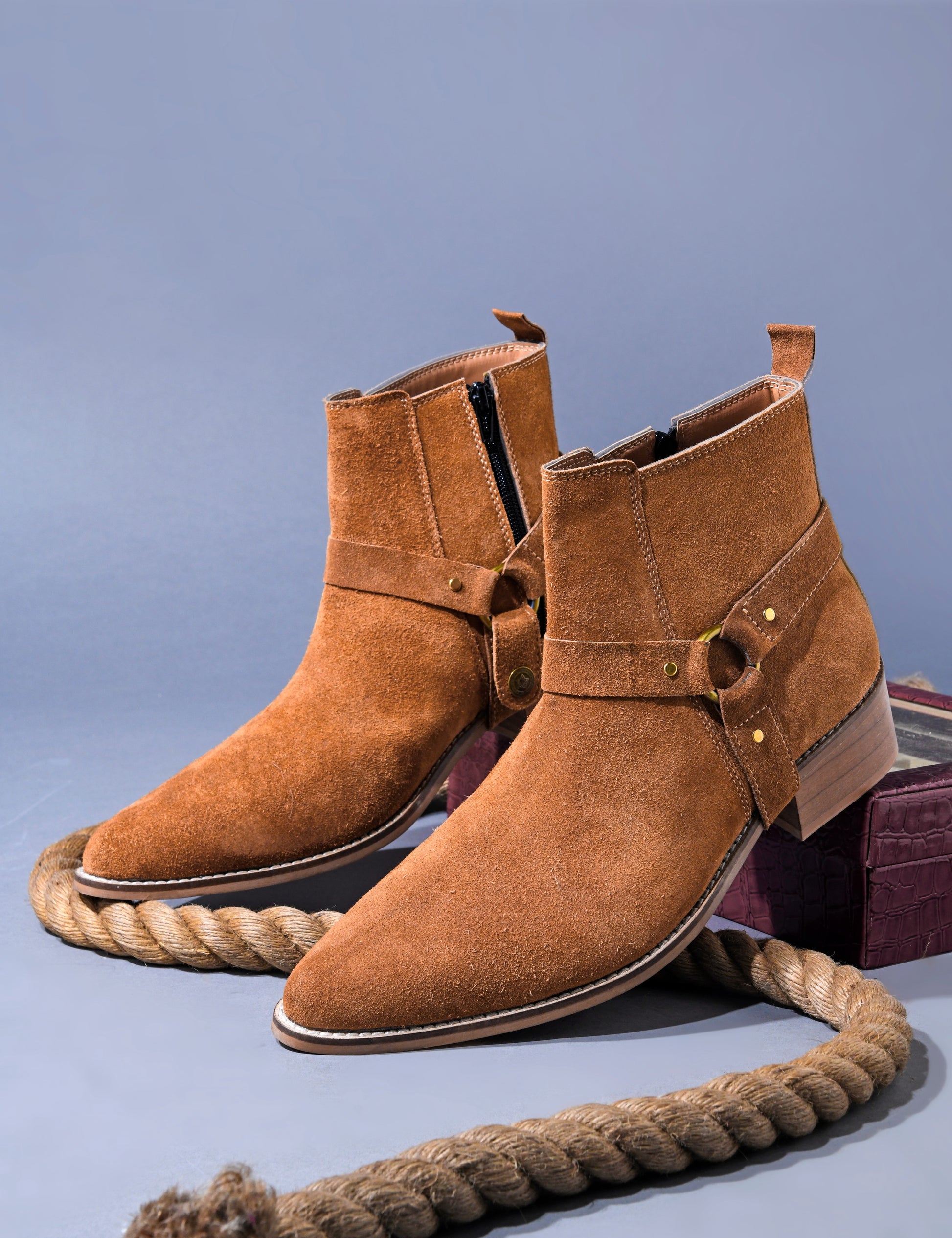 Pair of tan suede boots on Cuban heel with tan coloured buckle on side with golden accents