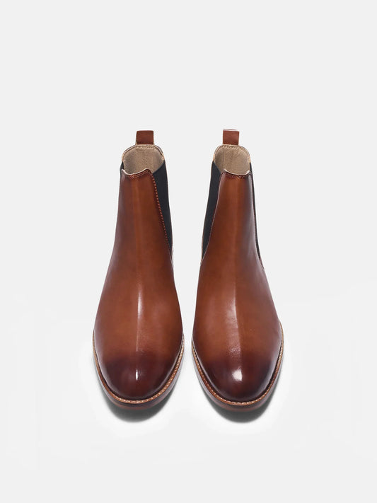 Brown leather Chelsea boot with side elastic and mid heel on a white background