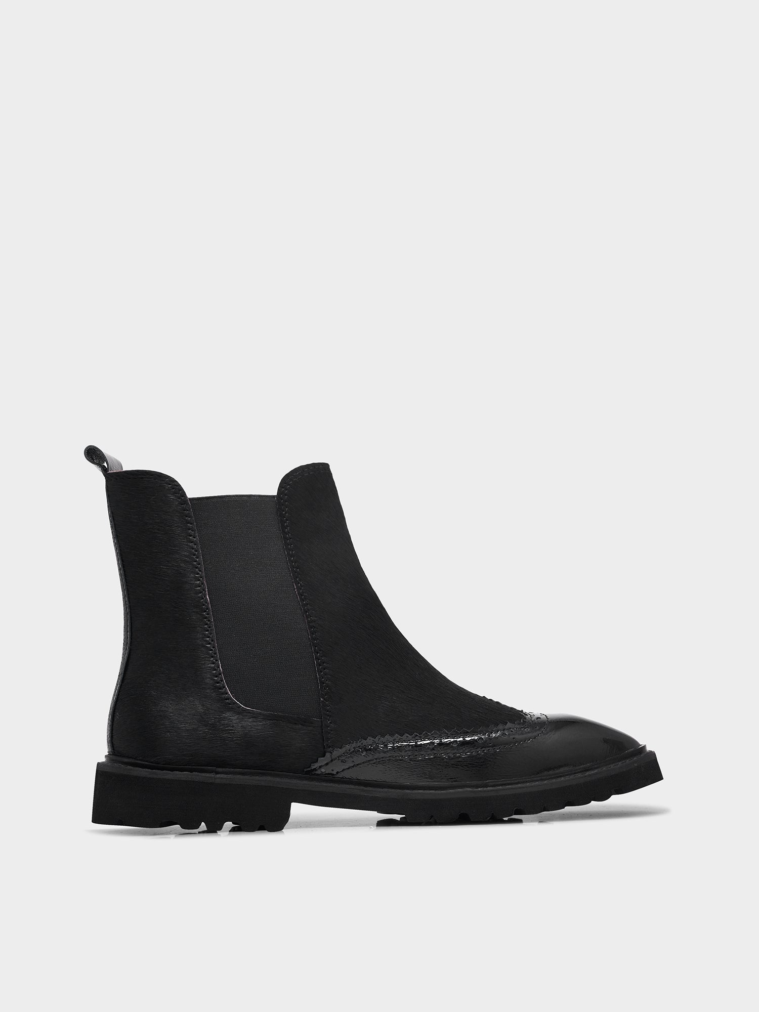 Black Chelsea boot on a white background