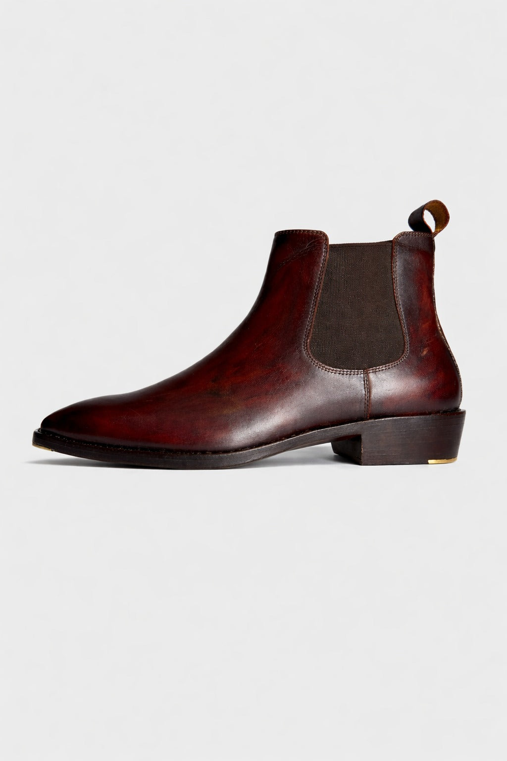 Brown leather Chelsea boot on a light gray background