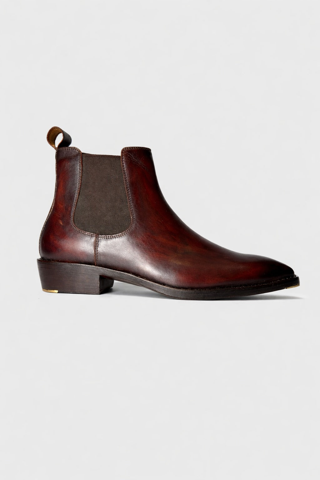 Brown leather Chelsea boot on a light gray background
