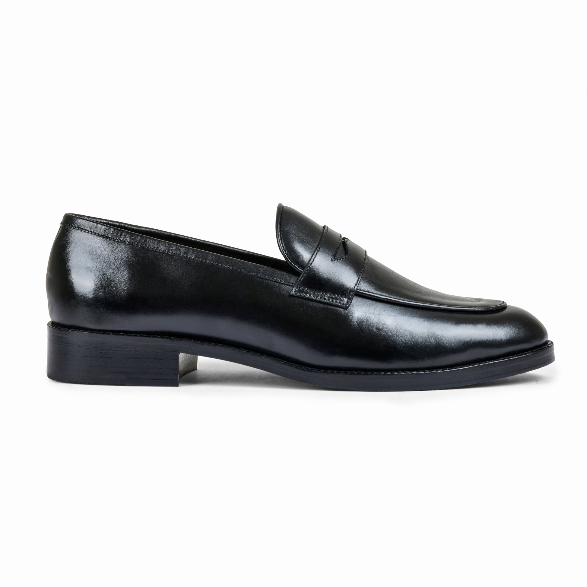 Black shoe with a decorative buckle on a light gray background