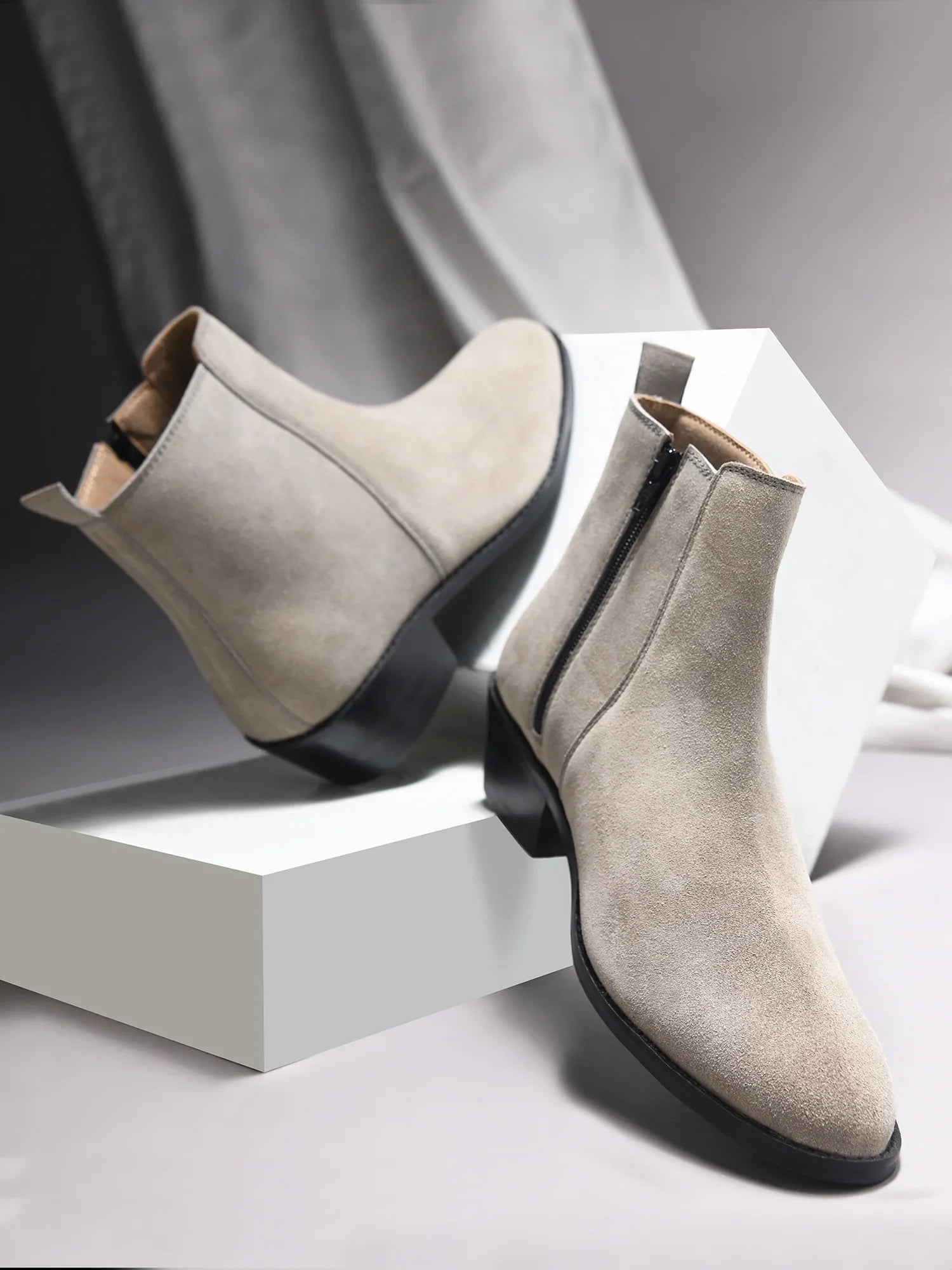 A men's luxury suede leather Chelsea boot with a cuban heel and zip side panels, in a gray color.
