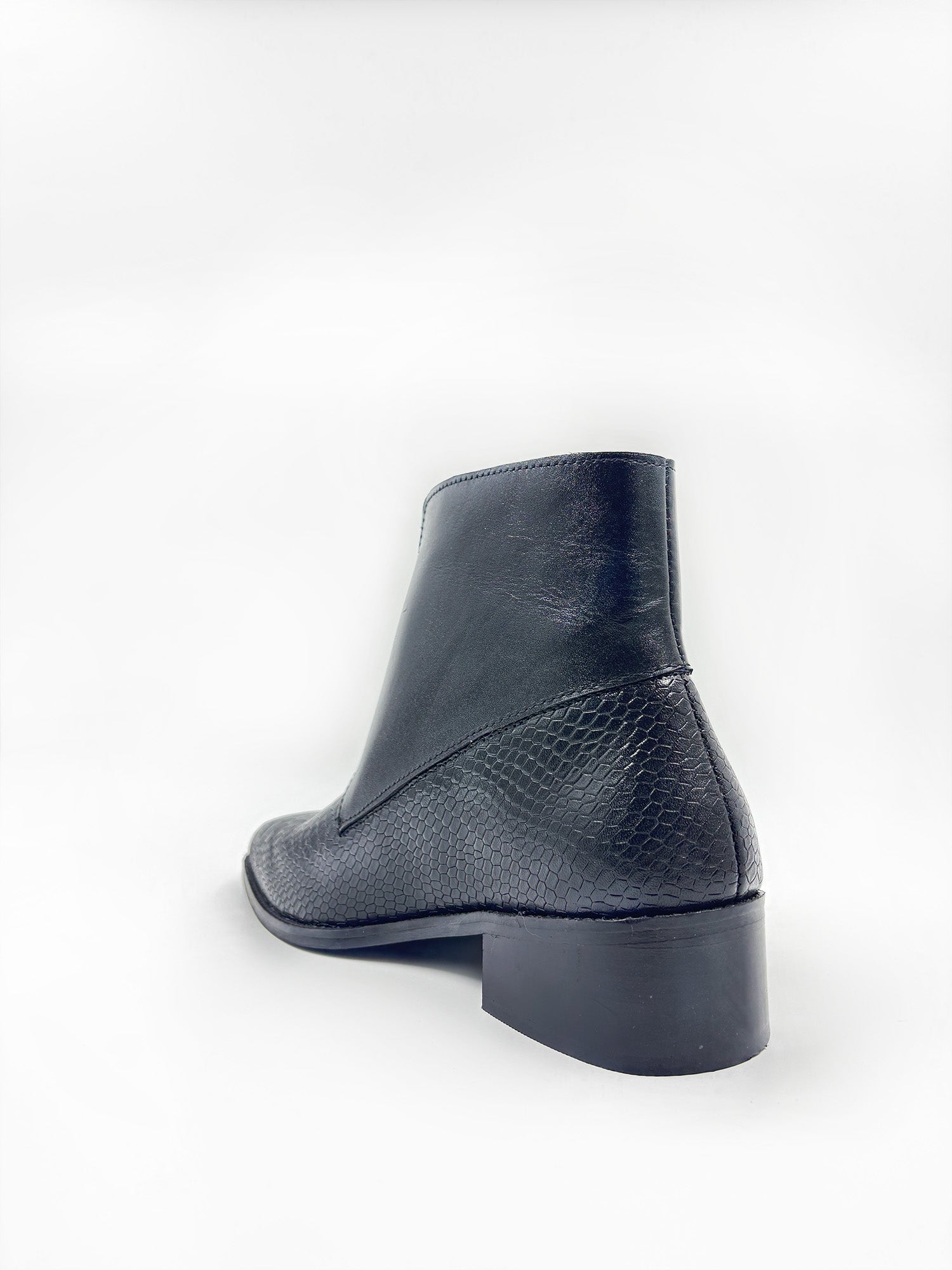 Black leather ankle boot on a white background