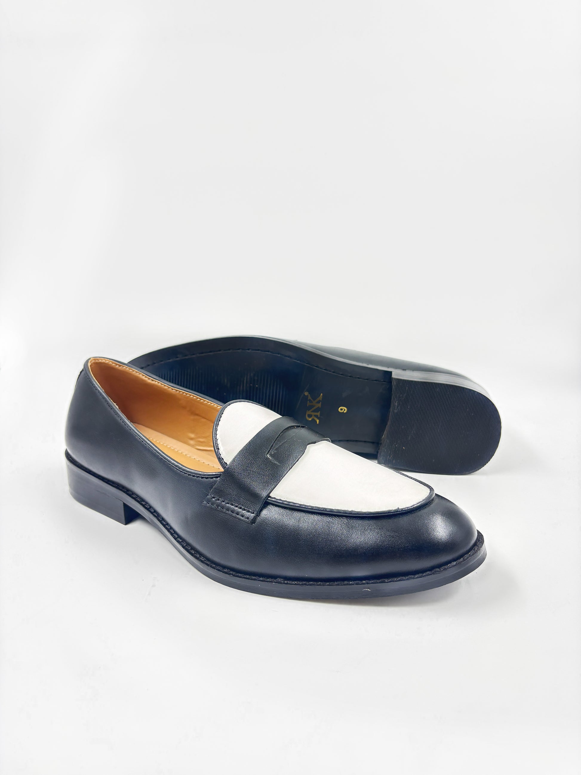 Black and white leather loafers on a mid heel 