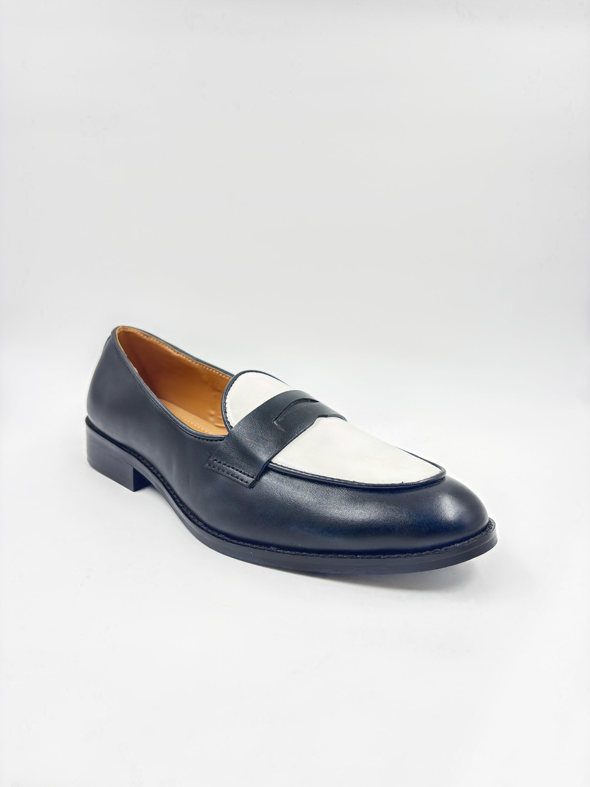 Black and white leather loafers on a mid heel 