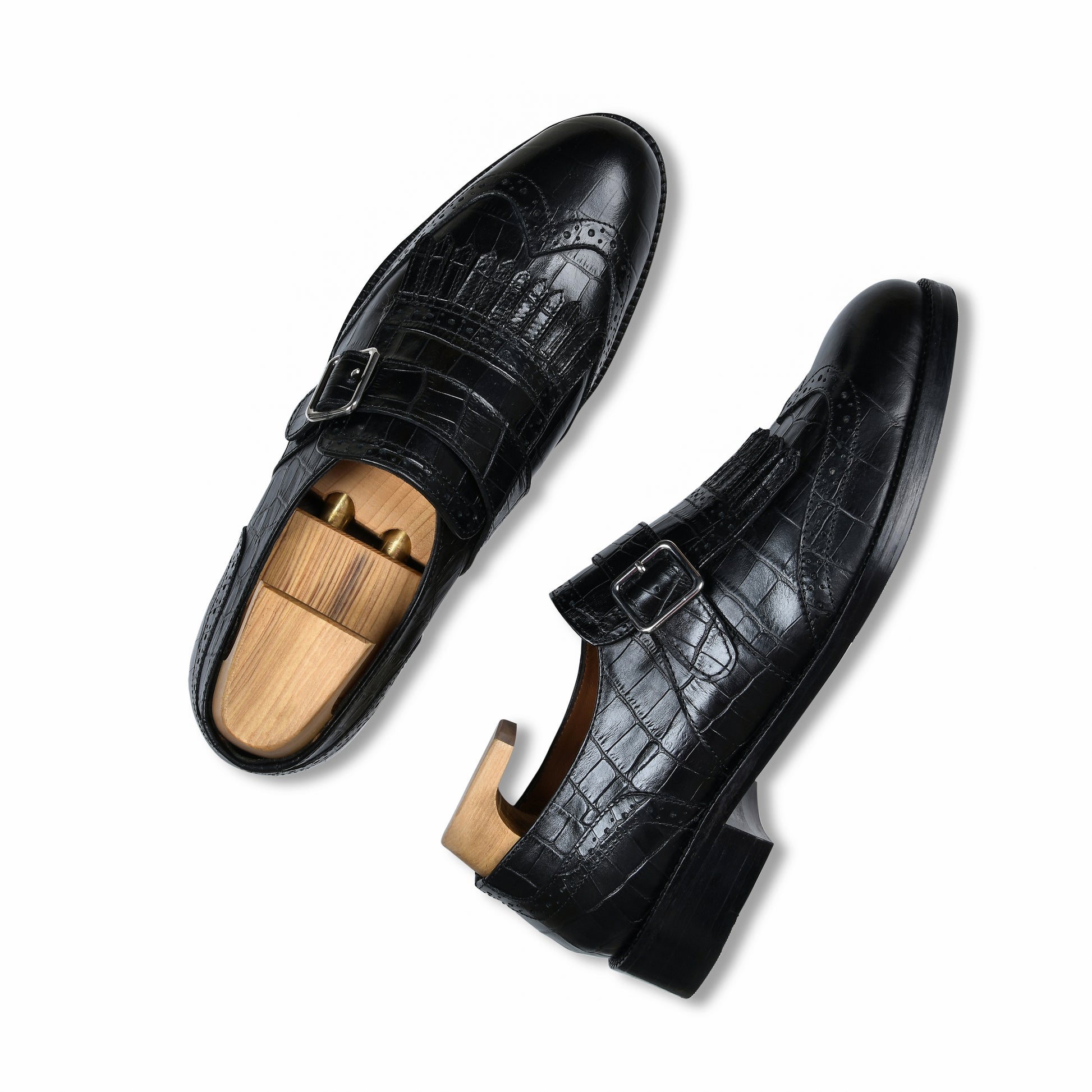 Black dress shoes with wooden soles on a white background